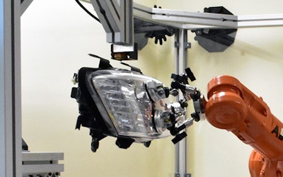 Robot 3D prints replacement bracket onto automotive part