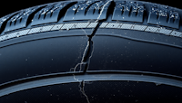 A tyre is shown with a crack in one side to demonstrate the power of self-healing materials using intrinsic or extrinsic means.