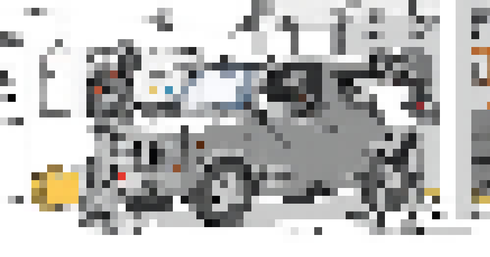 Three robots are seen inside a garage completing a car's MOT. One sits inside, one is checking the front, and one is stood to the side with a clipboard.
