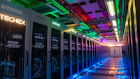 A data center is shown with lots of computing units in colourful lights.